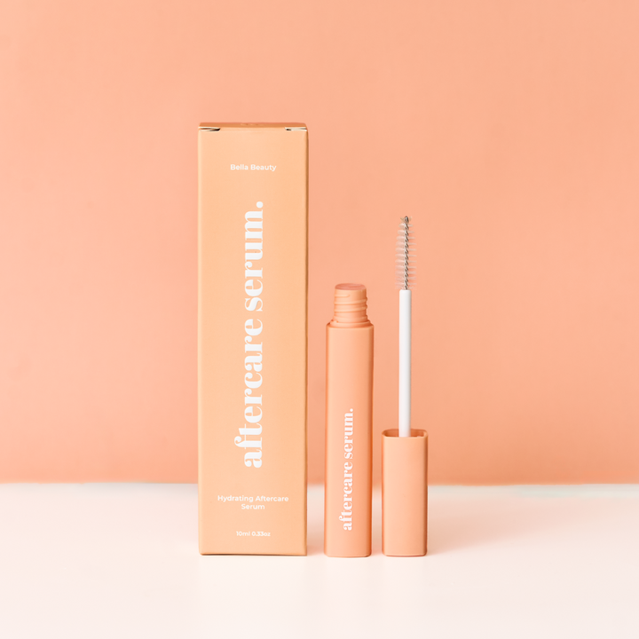Aftercare serum packaging and applicator on a peach background